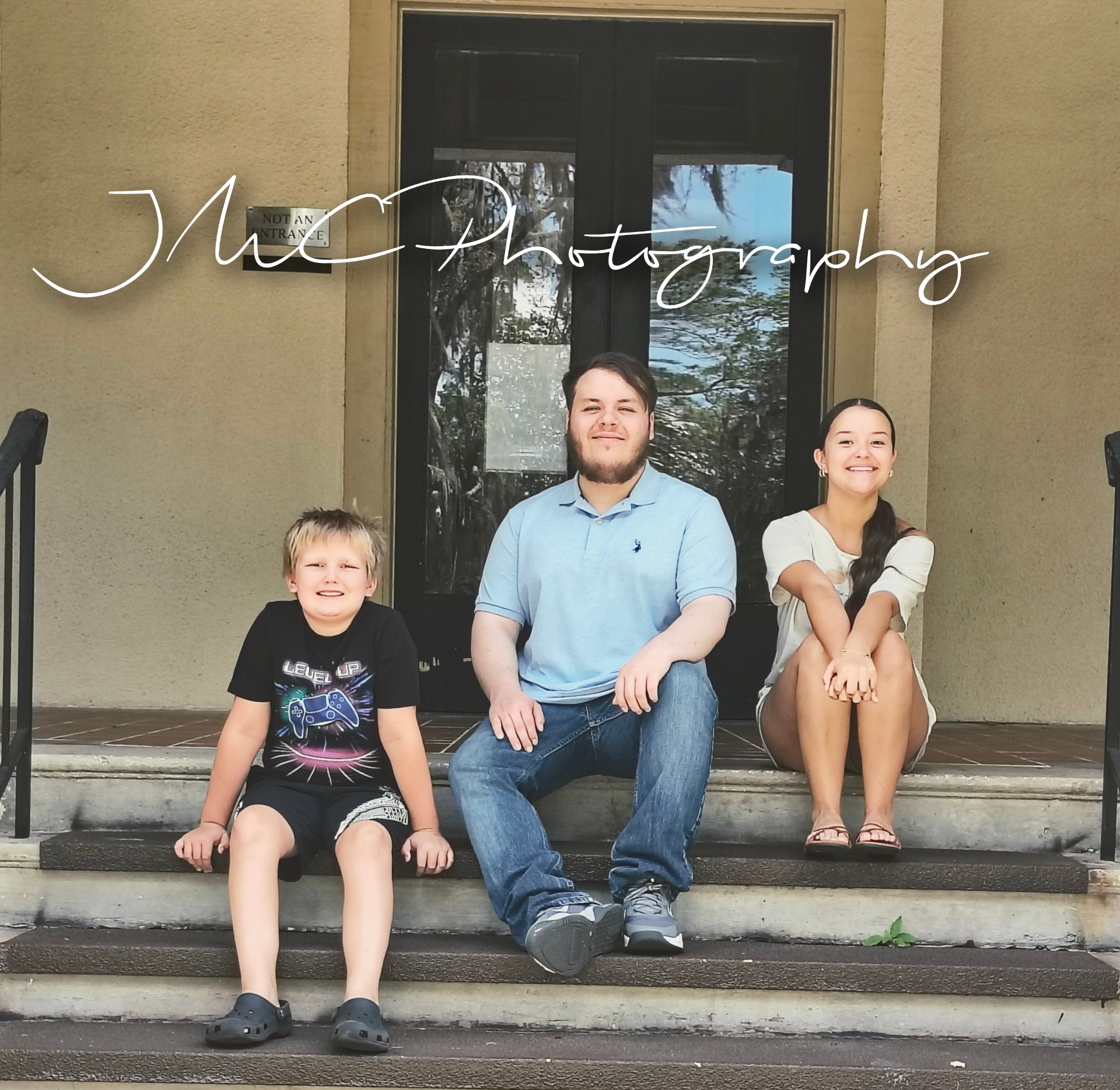Siblings sitting together on the front steps