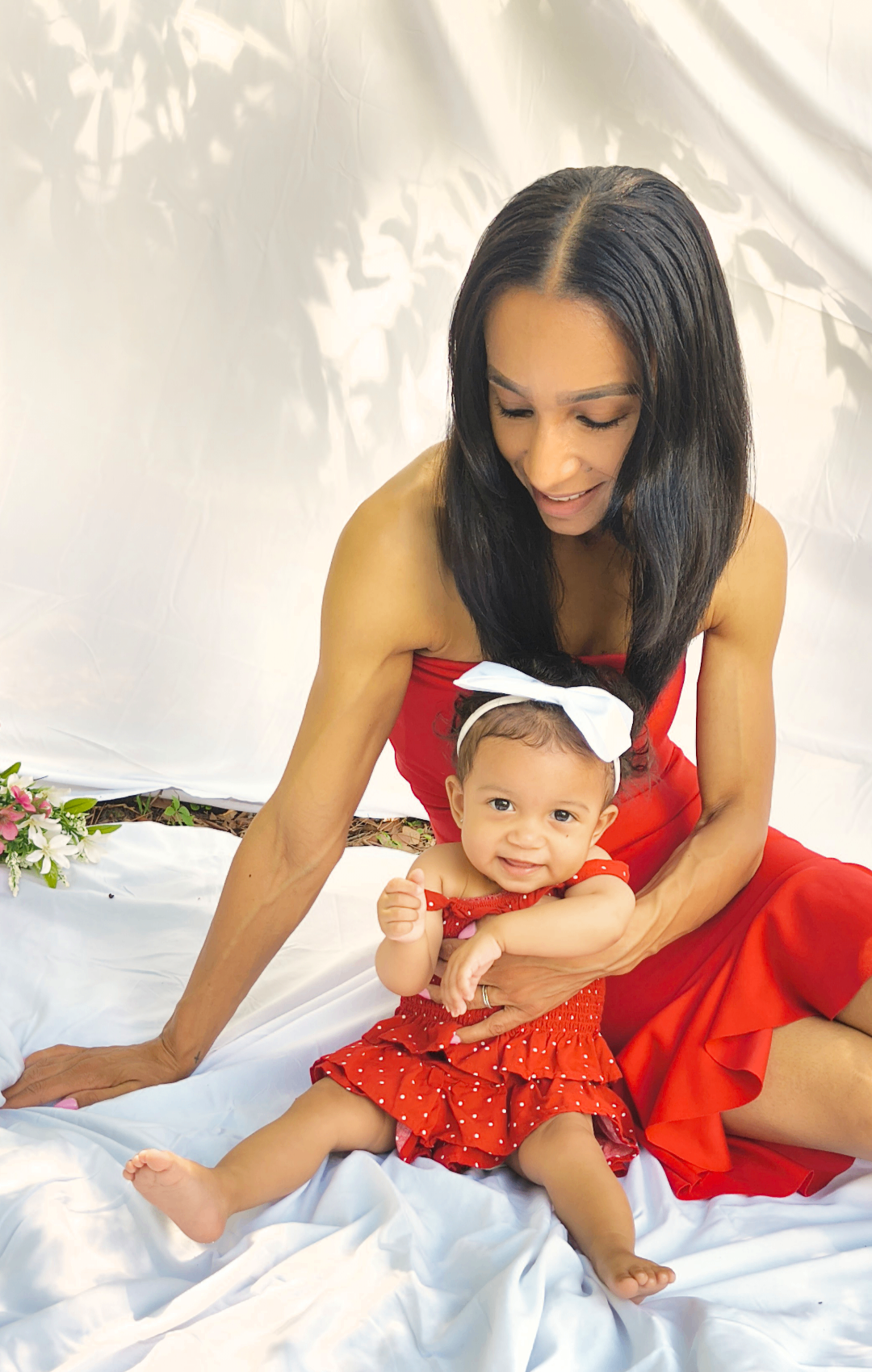 Mother cradling baby daughter in soft natural light