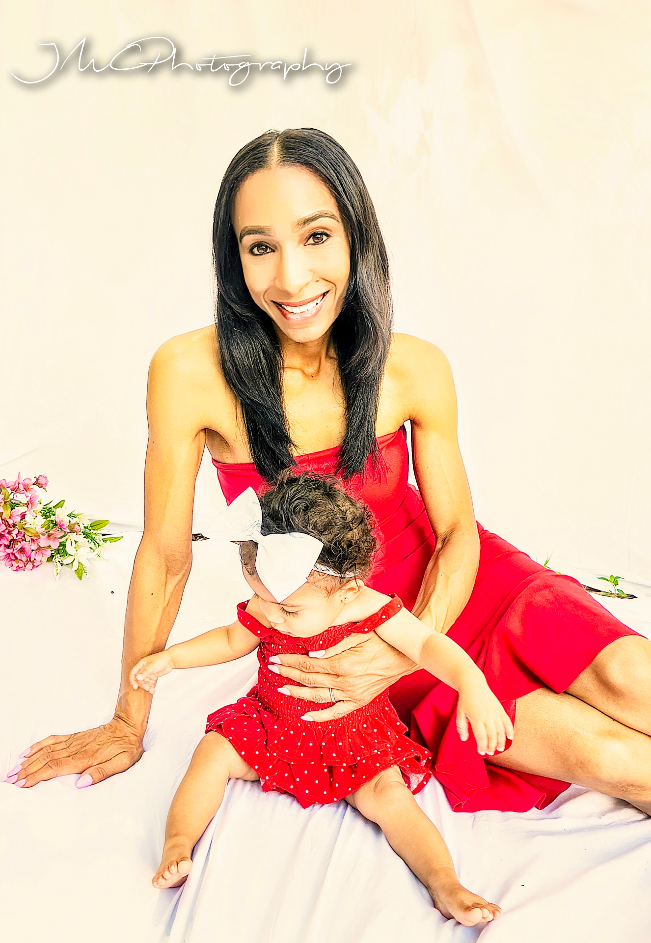 Smiling mother holding her baby girl close