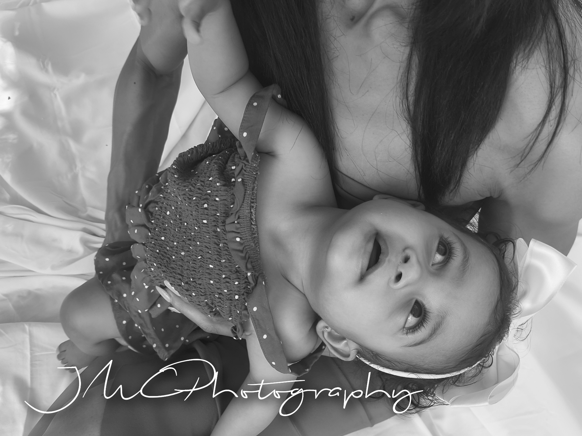Intimate black and white close-up of mother and baby