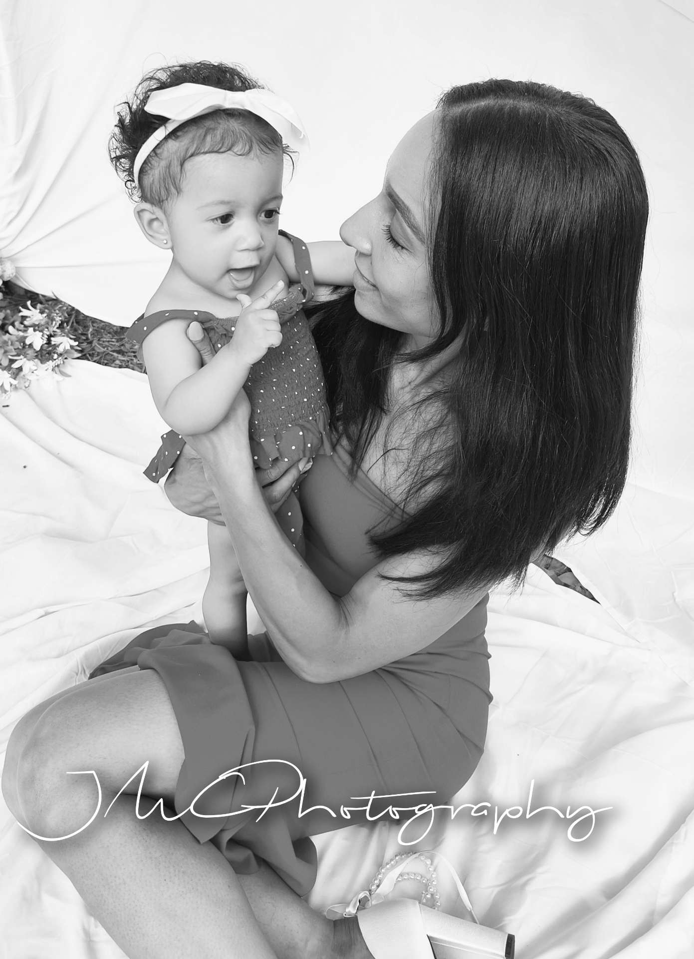 Black and white moment of mother and laughing baby